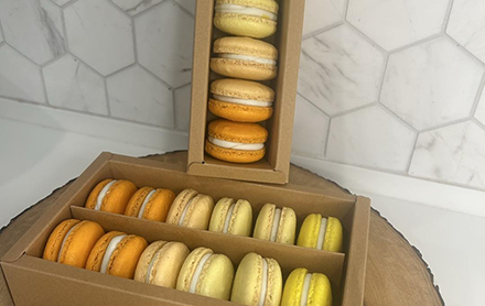 Pack of six macarons sold by Al Runs on Cake.