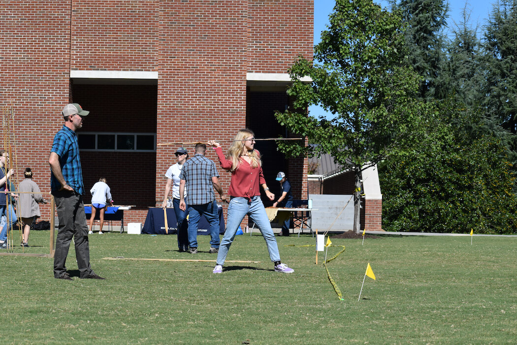 UTC student Abbey Fowler tests her atlatl skills. The atlatl is a spear-like weapon used by the Aztecs.