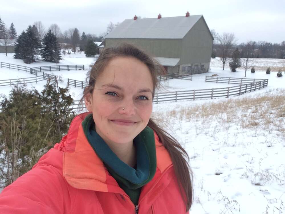 A photo of Dr. Meagan King with a barn in the background