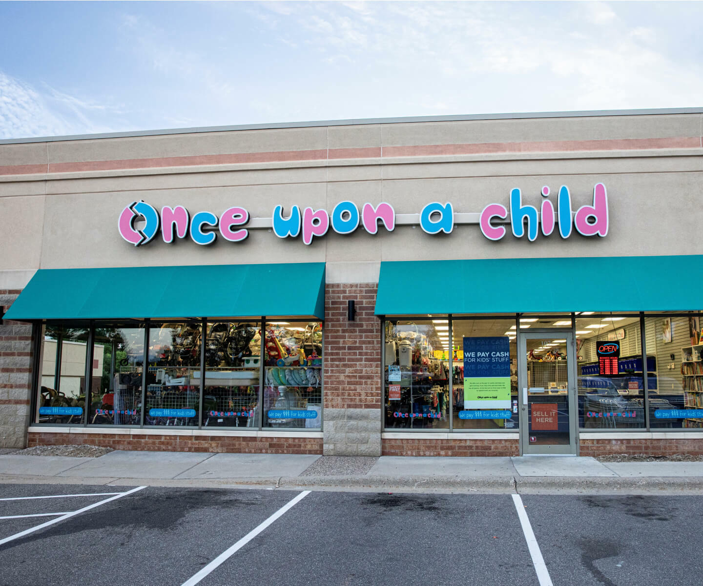 A store front with a big sign board on top that says "once upon child"