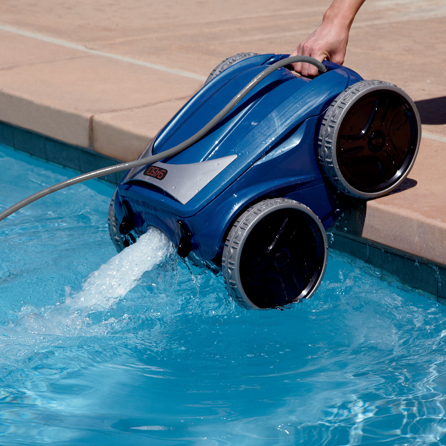 A pool vacuum cleaner filtering water into a pool