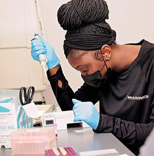 Fayetteville State University student Alexis Nealy works in a lab in the ECU Life Sciences and Biotechnology Building.