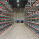 shelving down the aisle of a warehouse
