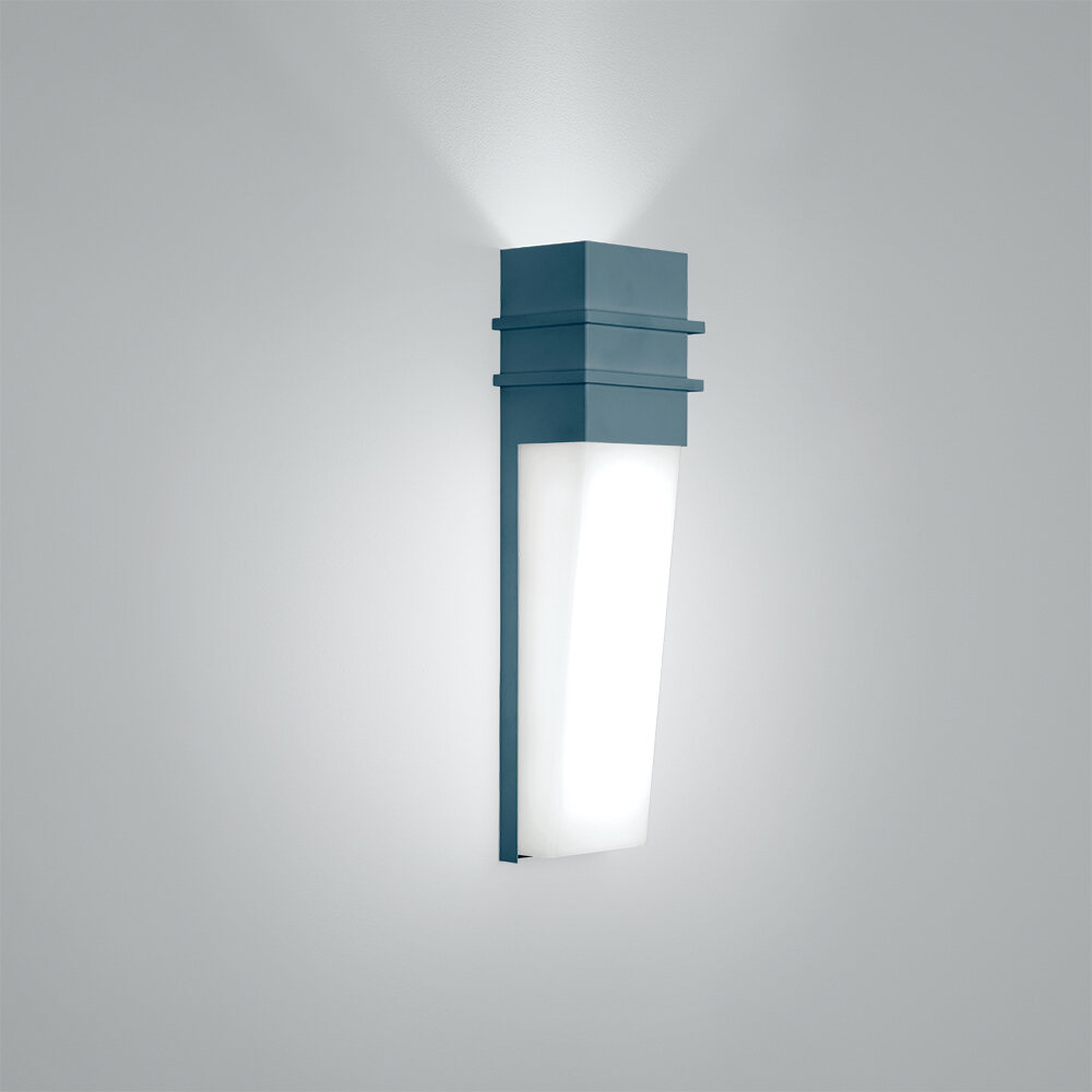 An indoor wall sconce in a solid wedge shape with uplighting