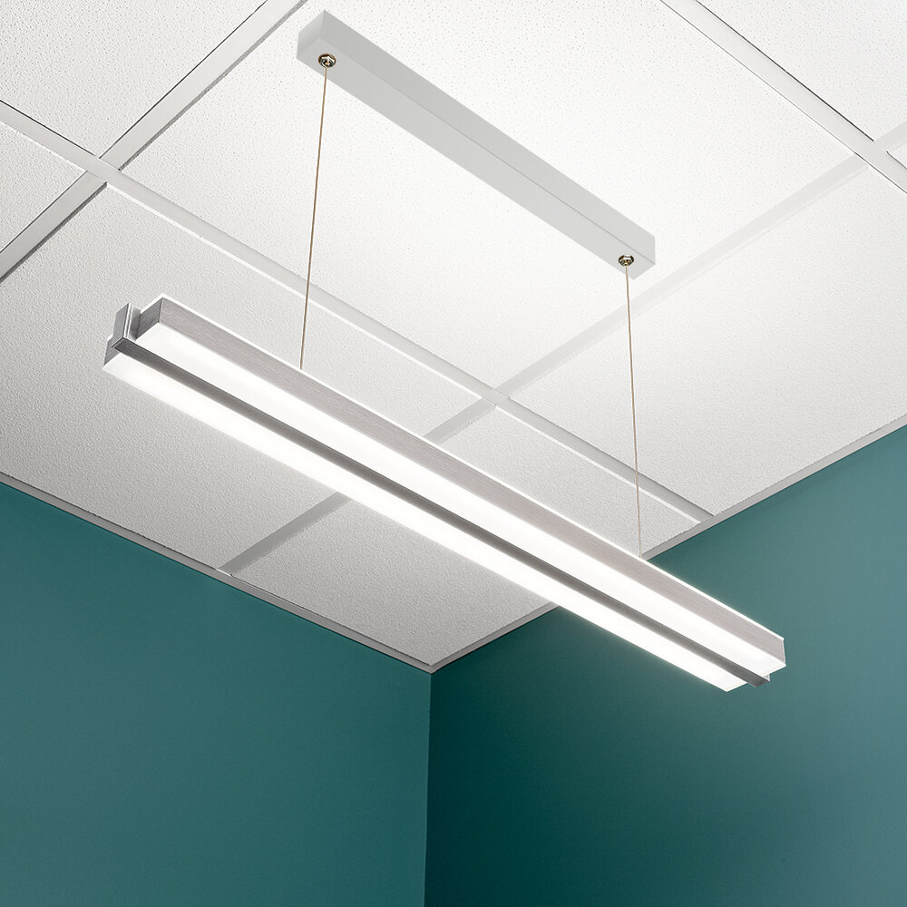 A thin, linear pendant suspended with aircraft cable