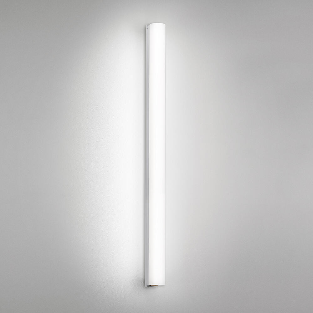 A thin linear surface-mounted luminaire with a fully luminous round body