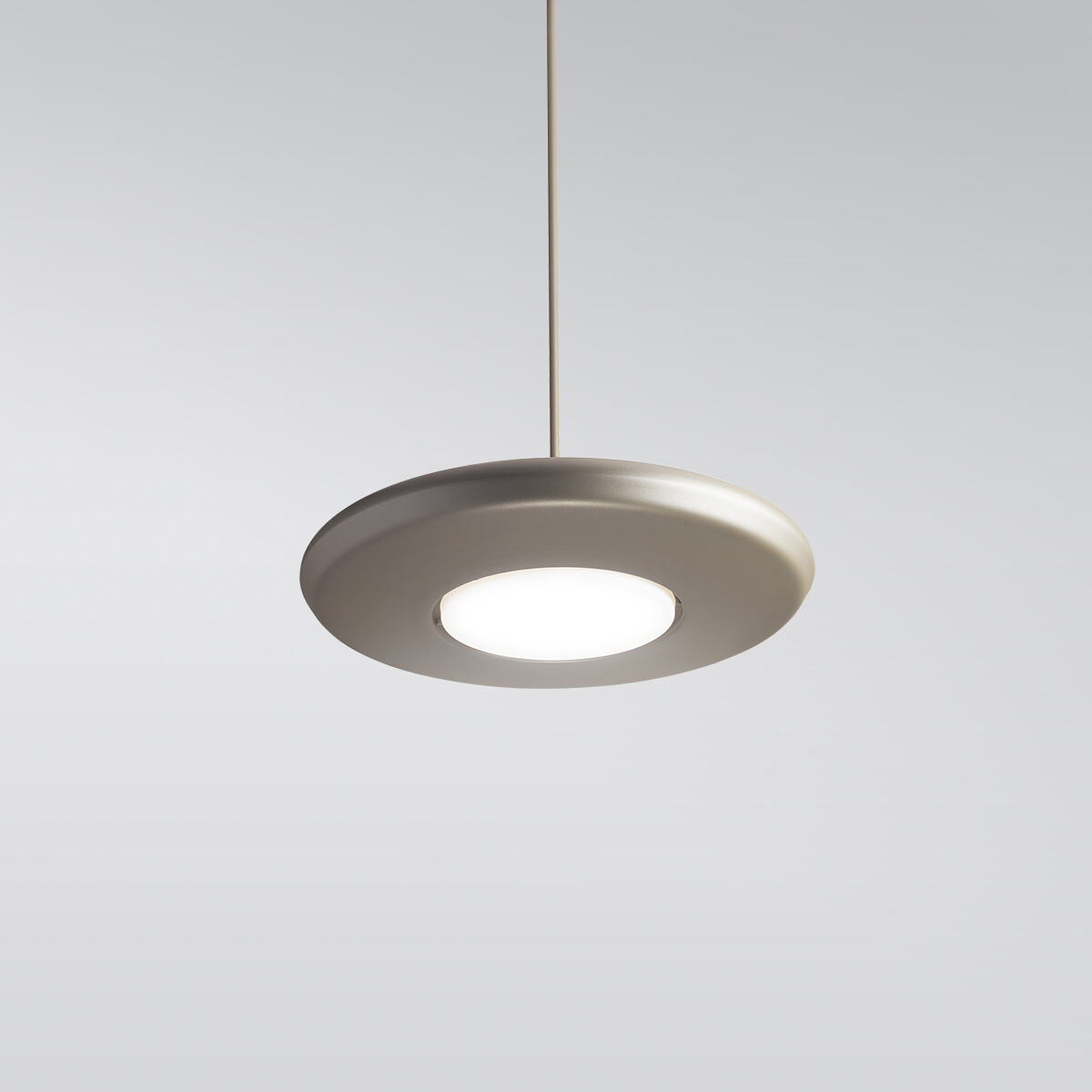 CP4450 Aries A round, disc-shaped pendant with a luminous downlight diffuser in the center