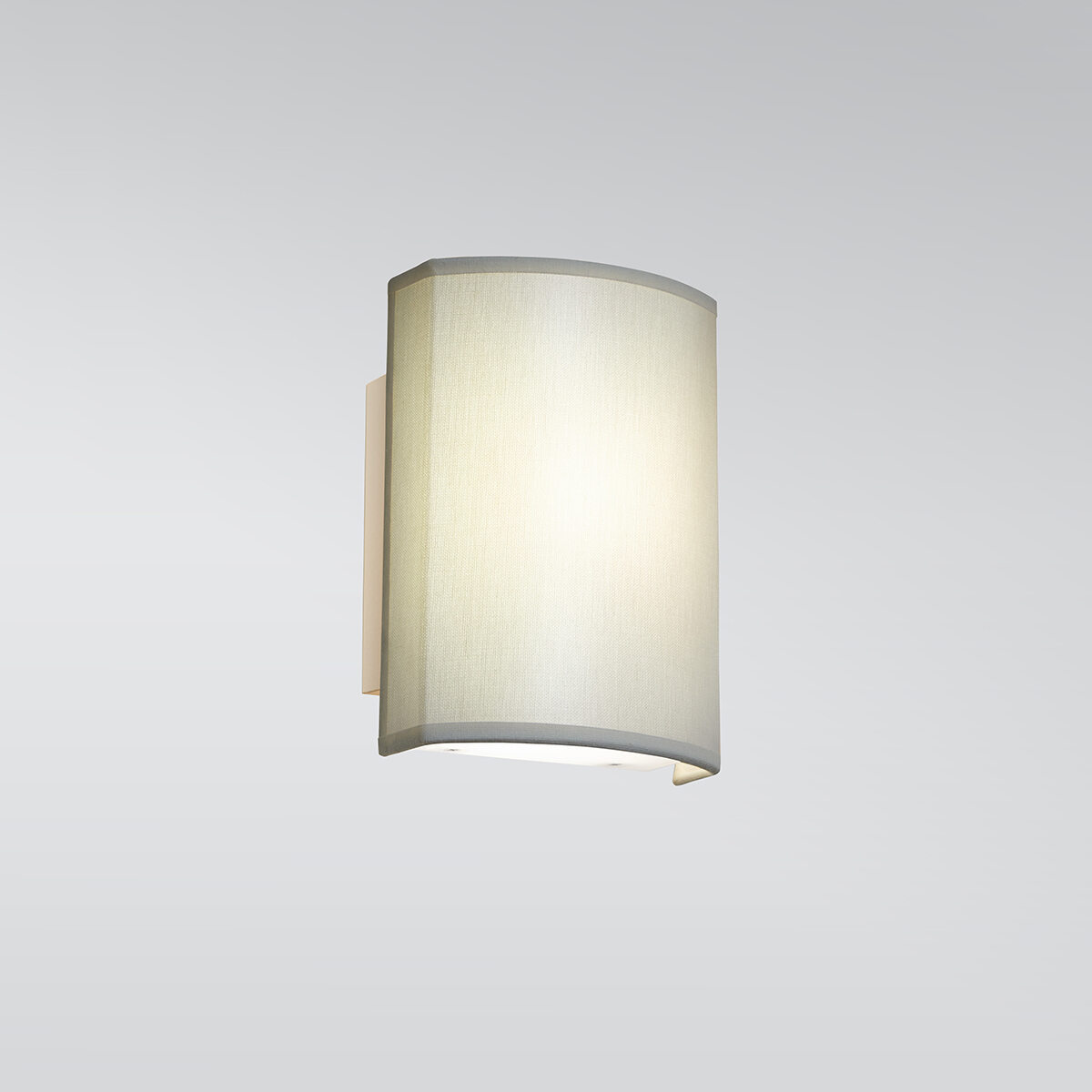 A small rectangular wall sconce with a fabric-looking shade