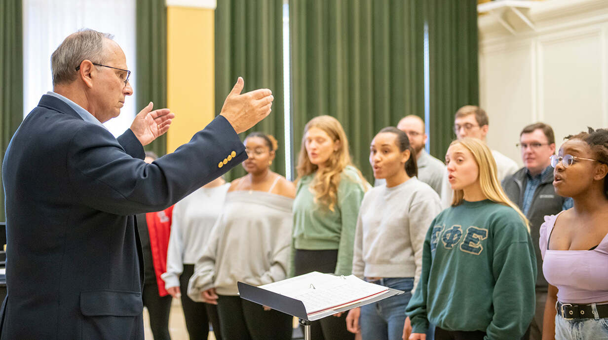 Don Trott (left) leads the UM Chorus in a practice session for a European tour. Photo by Srijita Chattopadhyay/Ole Miss Digital Imaging Services 