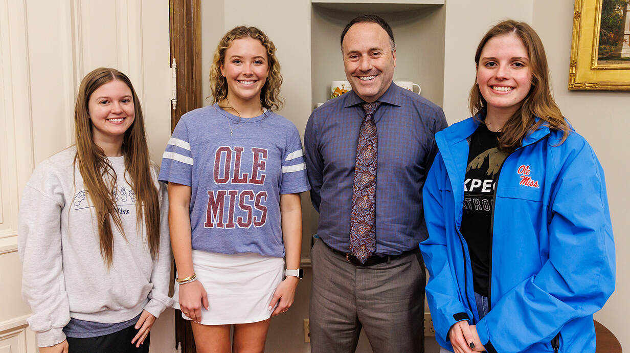 Reagan Houston (from left), a junior psychology major from Corinth; Alice Ann Hollingsworth, a senior English major from Jackson; and Elizabeth Hunt, a freshman chemical engineering major from Houston, Texas, meet Lee Cohen (second from right), dean of the College of Liberal Arts, before signing their names in the Ventress Hall turret on Giving Day 2024. Photo by Amy Howell/UM Development