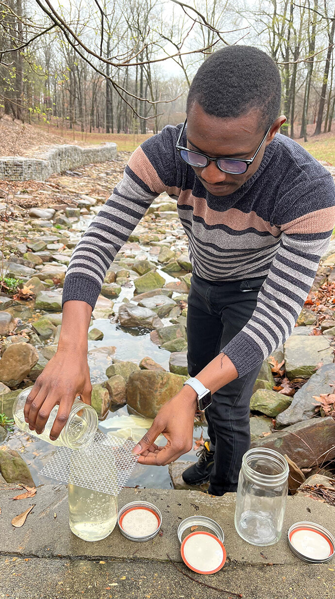 A researcher samples water runoff near a road.