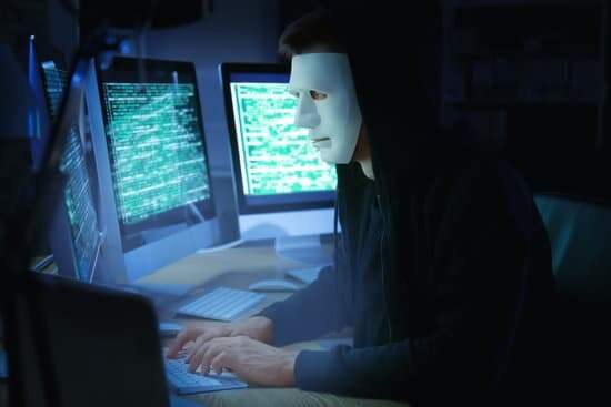 canva-masked-hacker-using-computer-in-dark-room.-threat-of-(2)