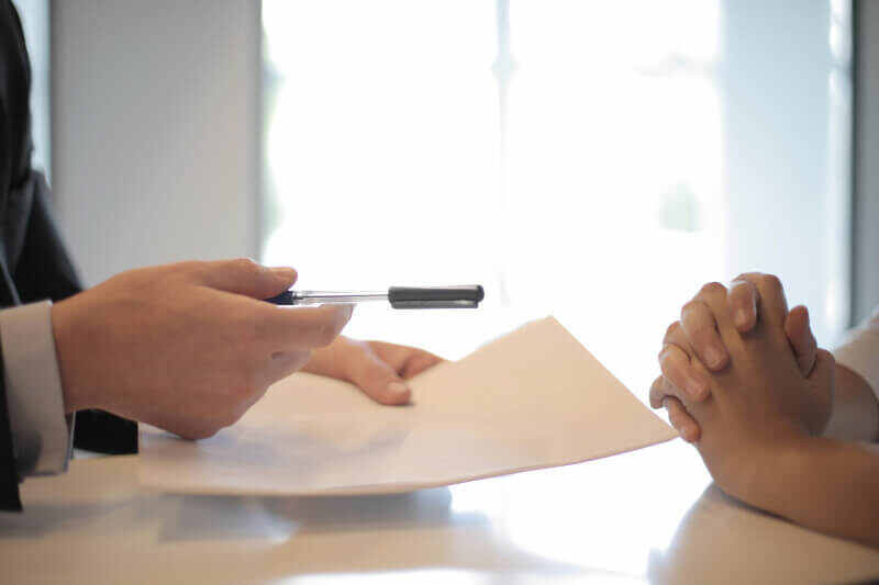 two people signing a general liability policy document