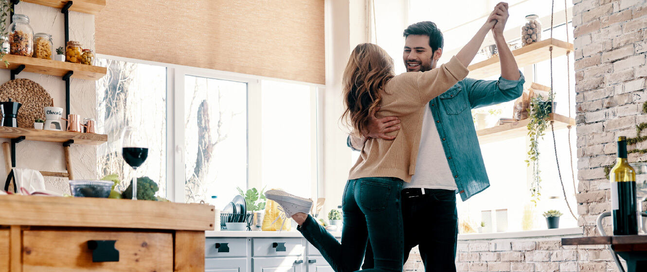 Couple dancing in their home together