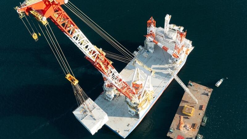 Top aerial shot of a Blue Wind Shimizu Crane on the water