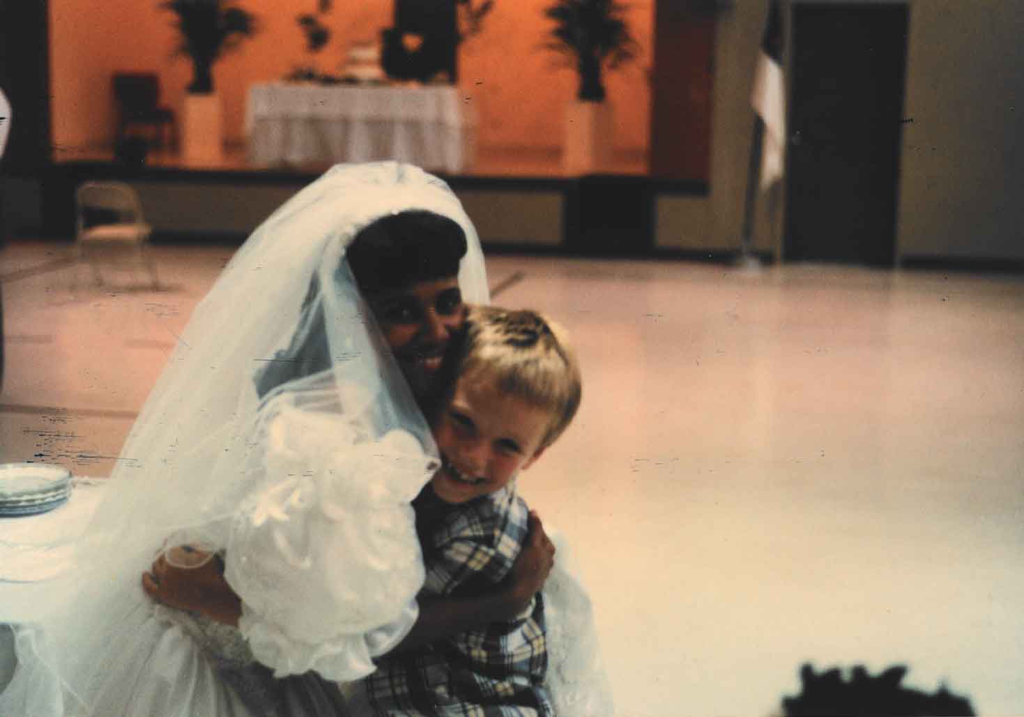 A young Aaron Hall hugs Yolanda Taylor-Statom at her wedding.