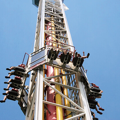 A group of riders on an amusement park ride. 