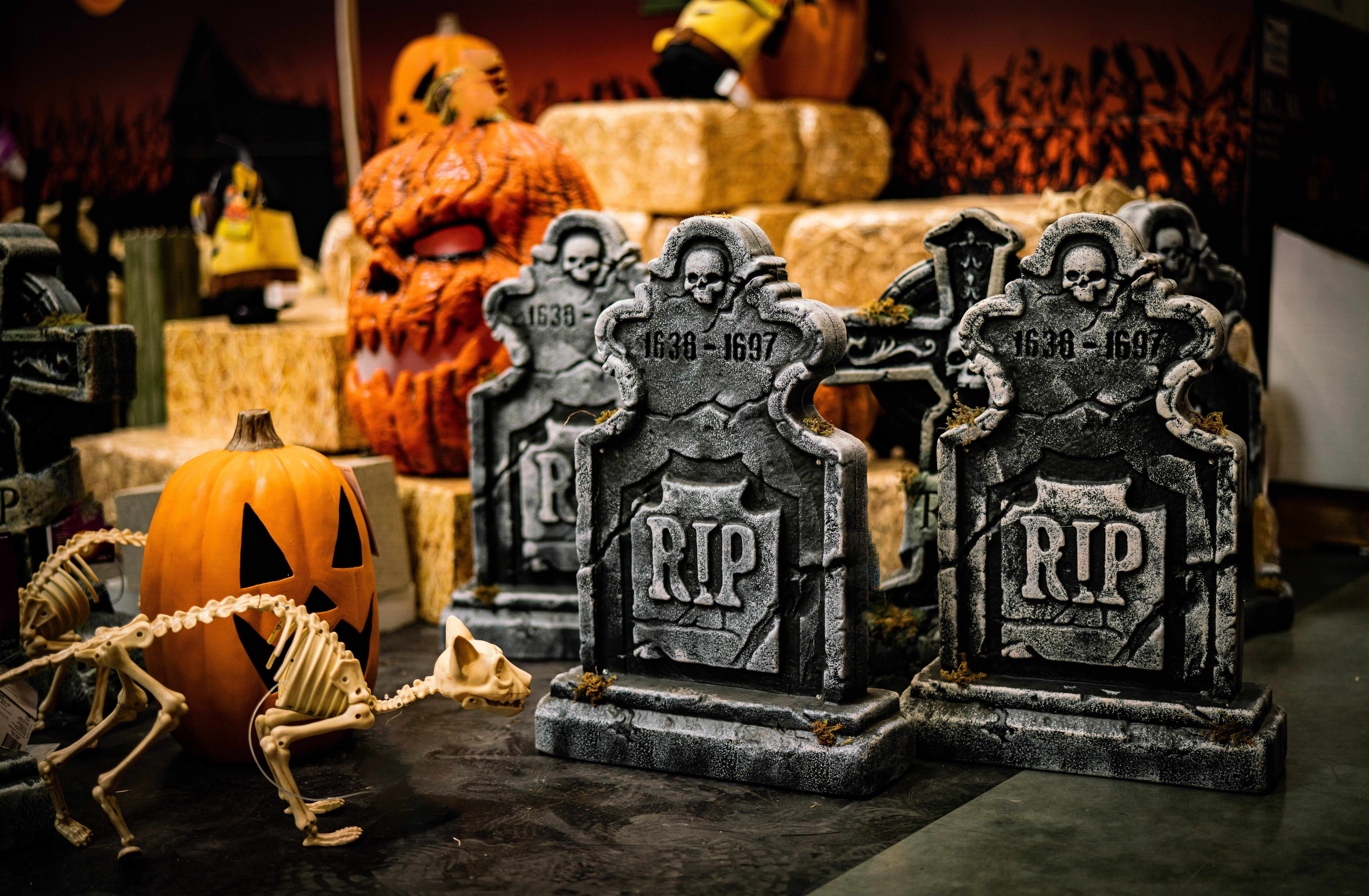 Halloween decorations including pumpkin, mini tombstones and skeleton cat