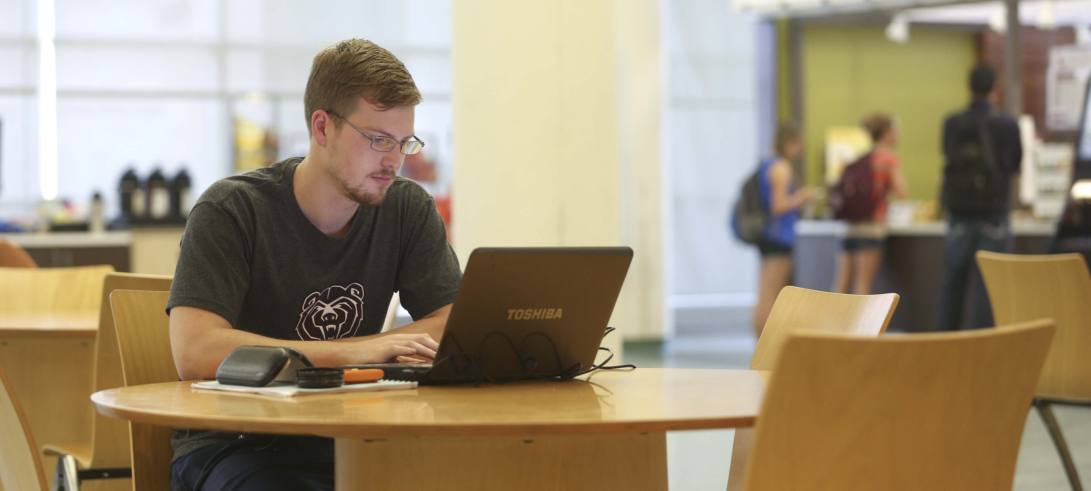 a student staring at his laptop and studying