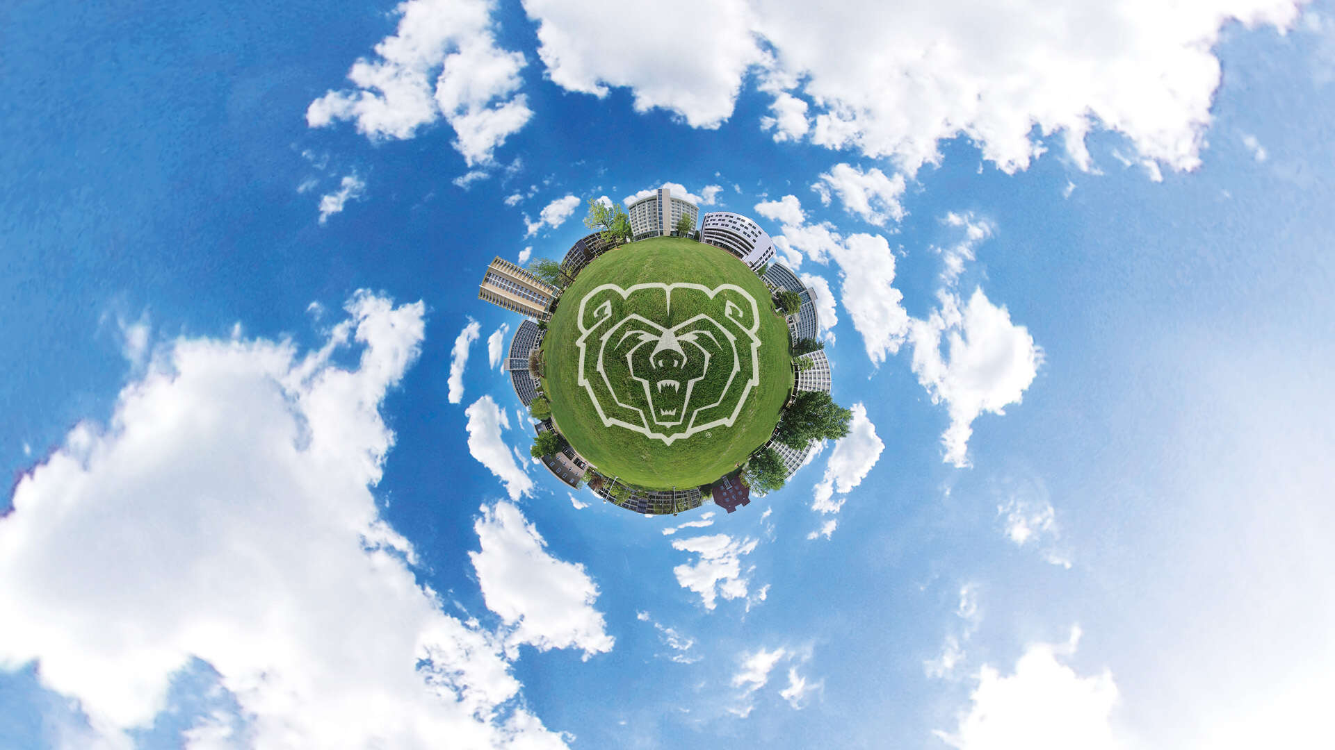 Photo collage of residence halls surrounding a tiny grass planet floating in a blue sky with clouds