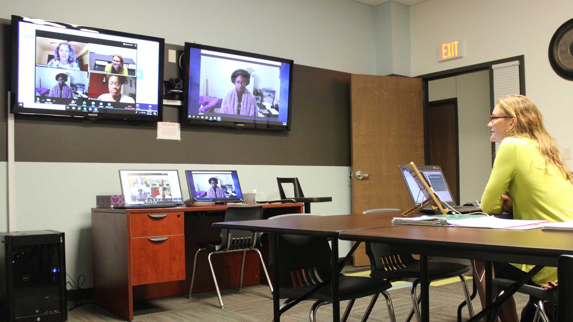 Professor speaking with students on multiple zoom screens