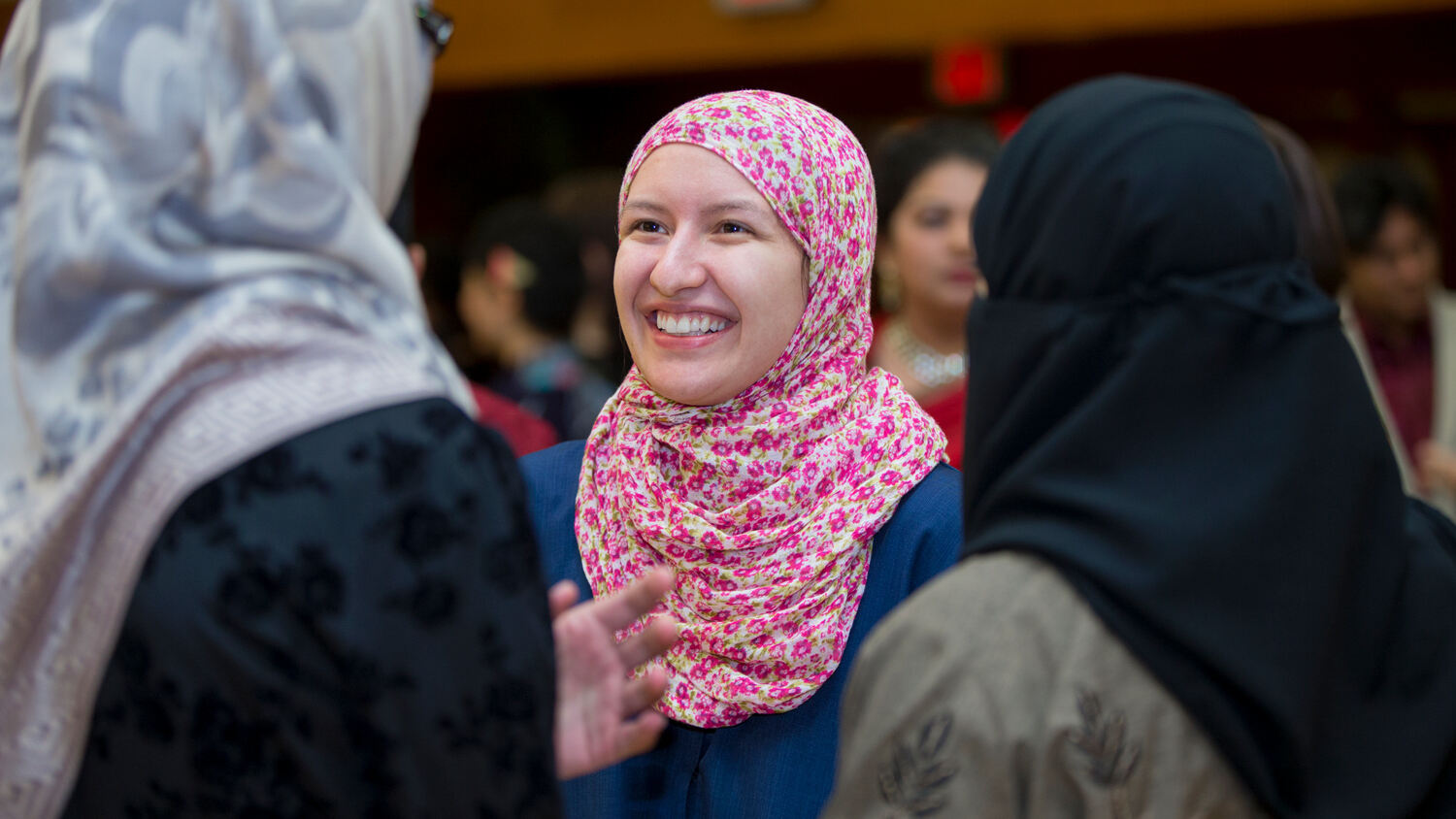 woman smiling, wearing a headscarf
