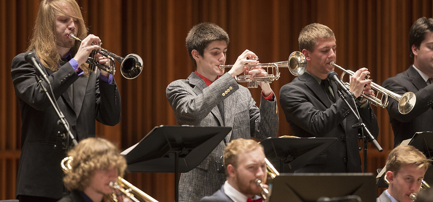 student trumpet players perform on stage