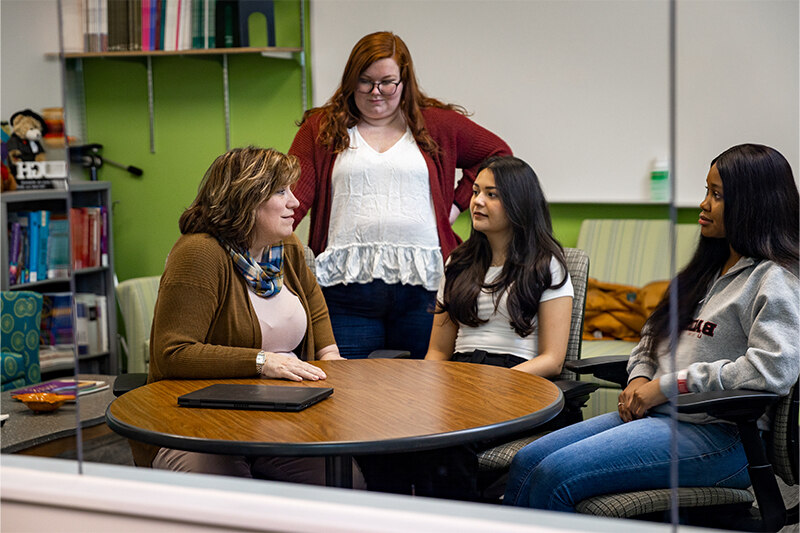 Professor Adrienne Newman meets with students