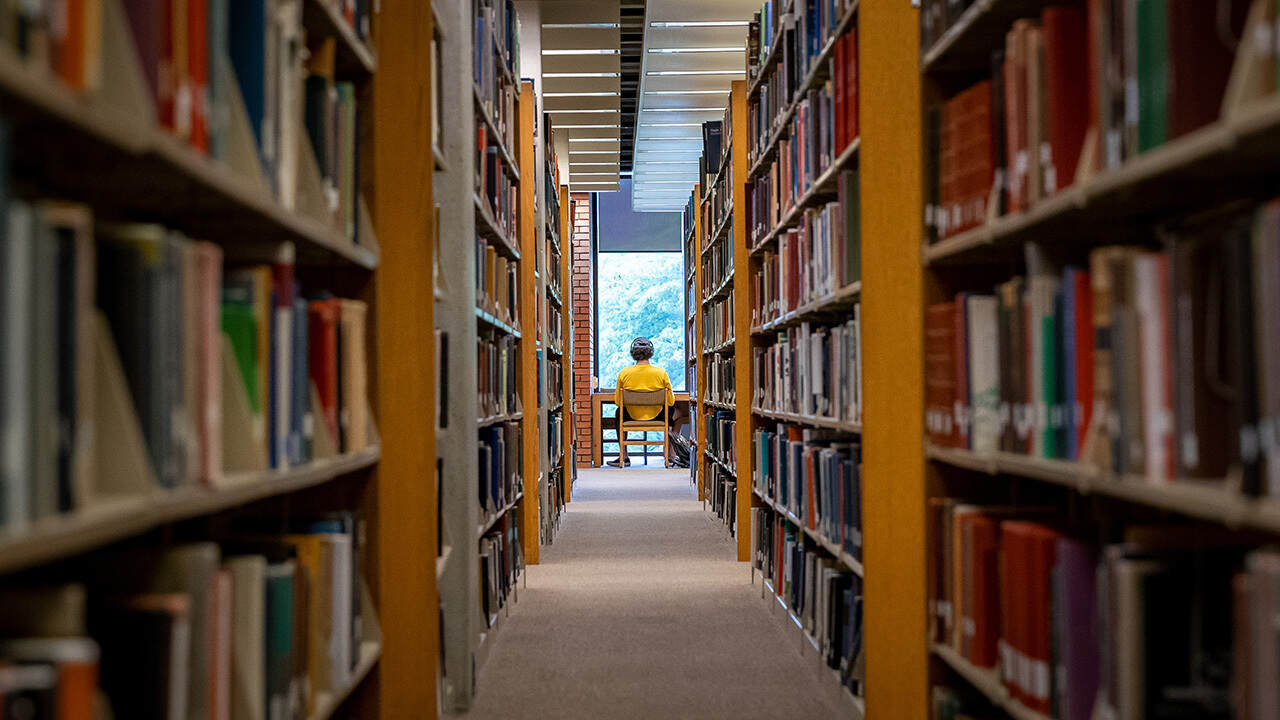 Student at end of bookshelves