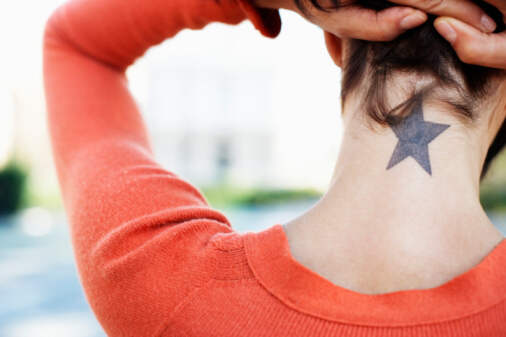 Star shaped tattoo on neck