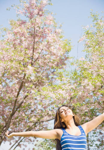 Happy woman enjoying spring outdoors