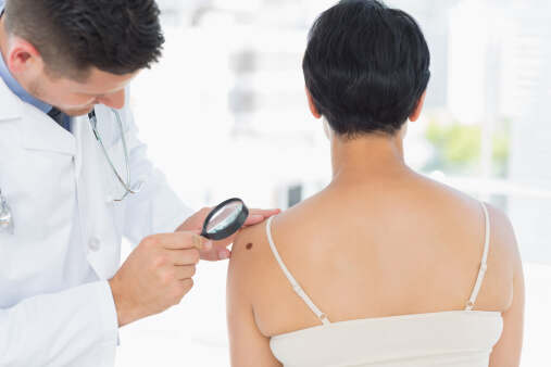 Woman getting her skin checked from dermatologist
