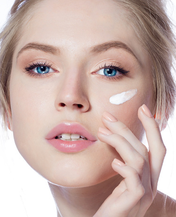 Lady applying Skin Moisturizer cream on her skin 
