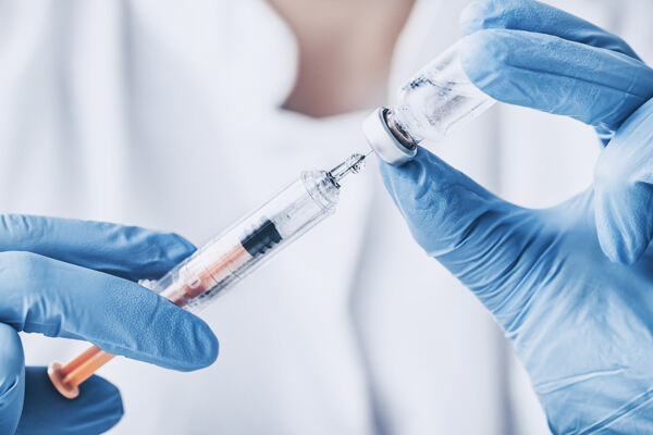 Dermatologist filling syringe with botox filler