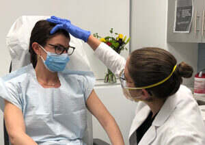 Provider examining patient for acne