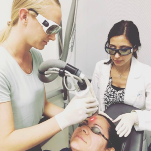 Lady getting Fraxel laser treatment by a doctor