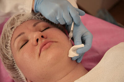 Patient getting facial wrinkle fillers by the provider