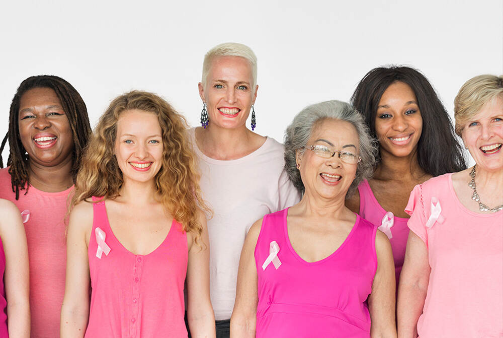 A group of women wearing pink shirts