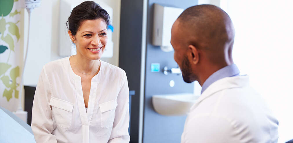 Woman talking with a male doctor