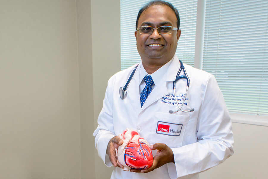 Dr. Prasad holding a heart model